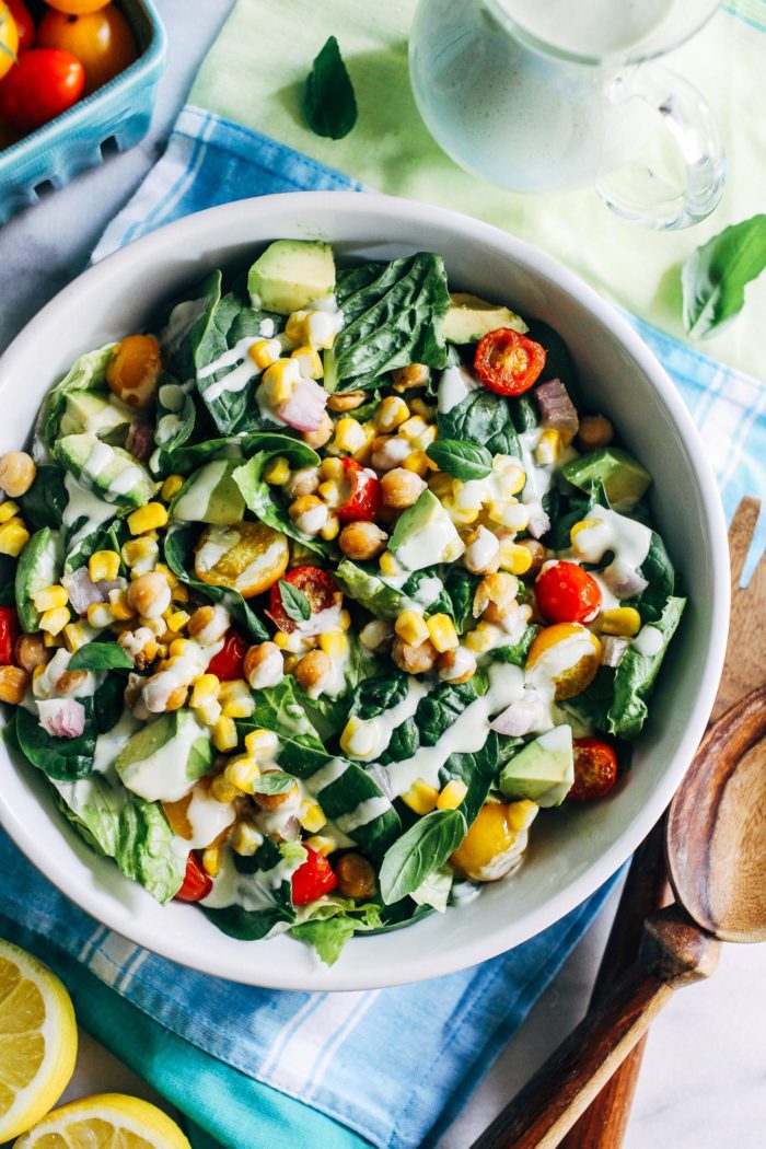Roasted Corn Tomato Summer Salad with Lemon-Basil Yogurt Dressing- crisp lettuce topped with roasted chickpeas, sweet corn, creamy avocado and juicy tomatoes then finished off with a flavorful yogurt dressing. The best of what summer has to offer! (vegan, gluten-free, grain-free)