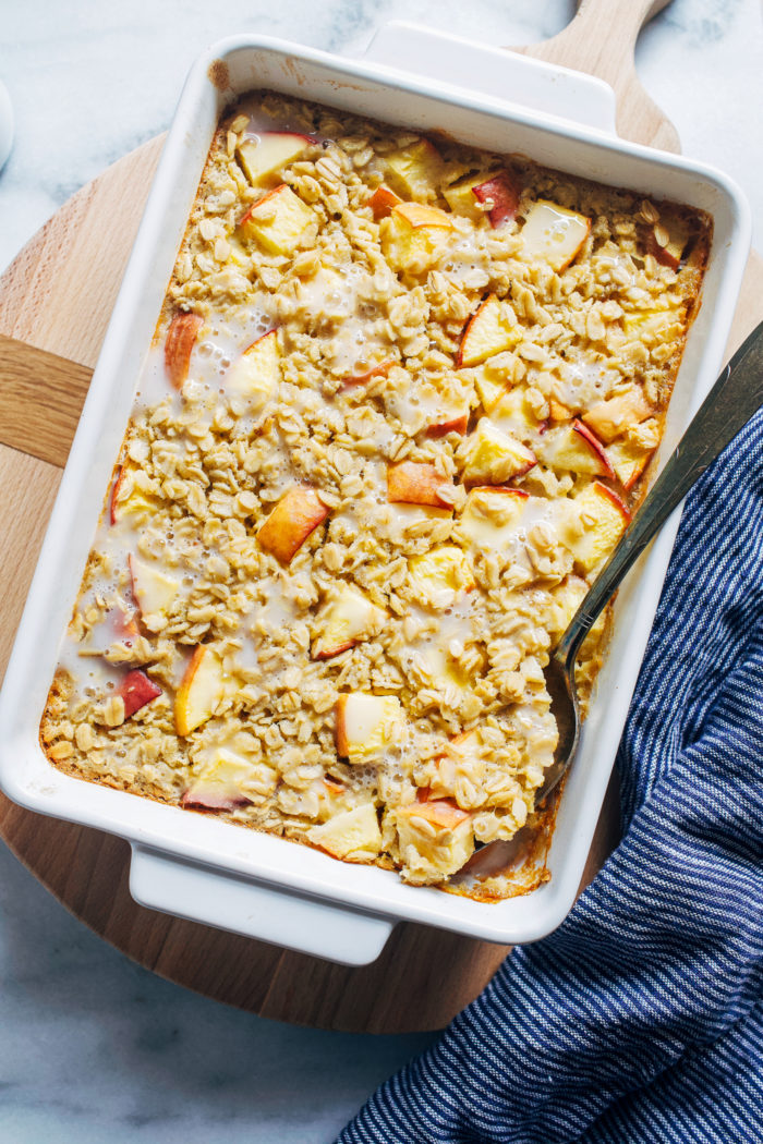 Peaches and Cream Baked Oatmeal- made with juicy peaches and dairy-free milk, this prep ahead breakfast will keep you full and satisfied for hours. Dairy-free and gluten-free with vegan option.