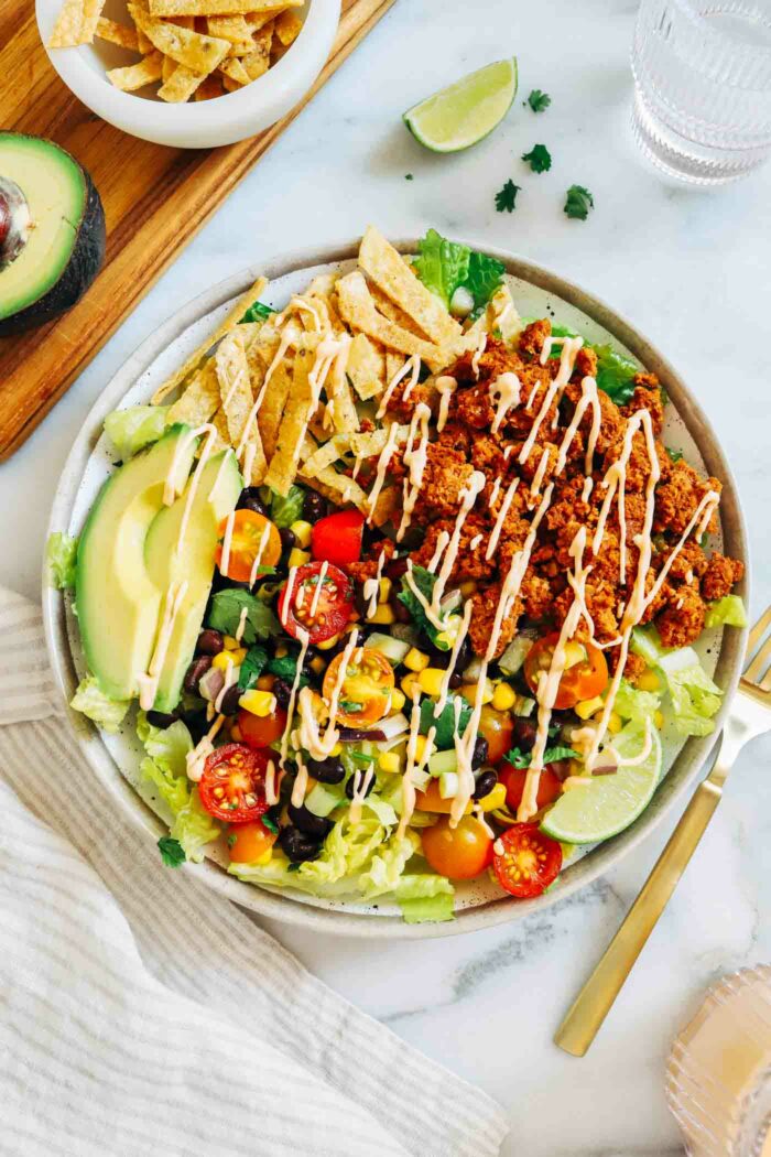 Vegan Taco Salad with Chickpea 'Beef'- the ultimate whole food plant-based taco salad! Packed with flavor and 22g of plant powered protein.