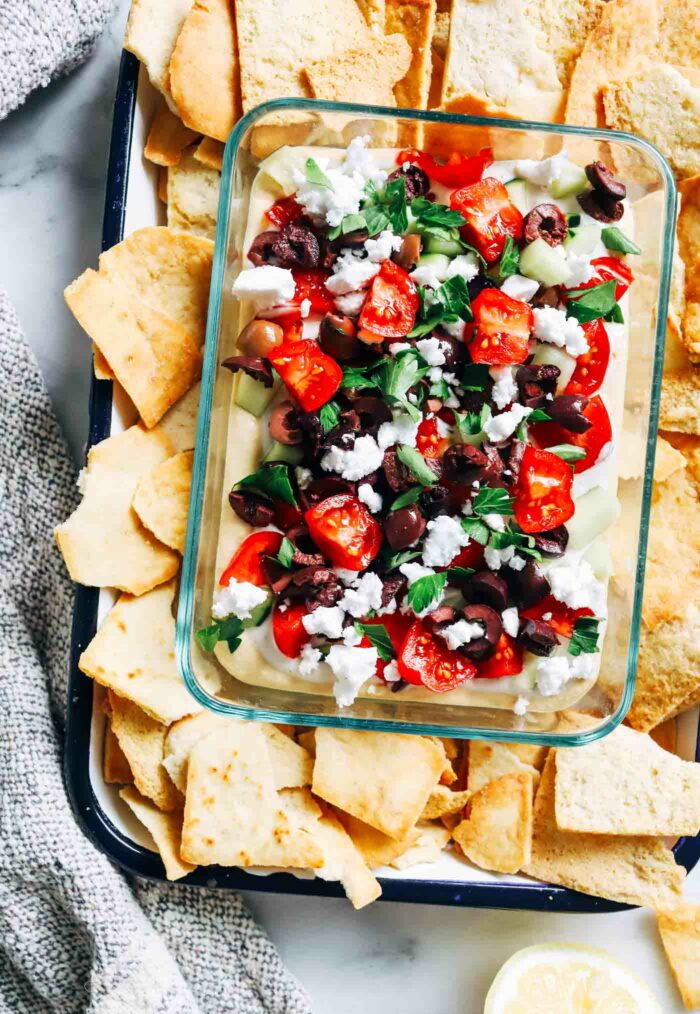 Three Layer Mediterranean Hummus Dip- Made with hummus, tzatziki, fresh herbs and vegetables, this Greek-inspired dip takes just 15-minutes to make and is perfect for a summer picnic! (dairy-free + gluten-free)