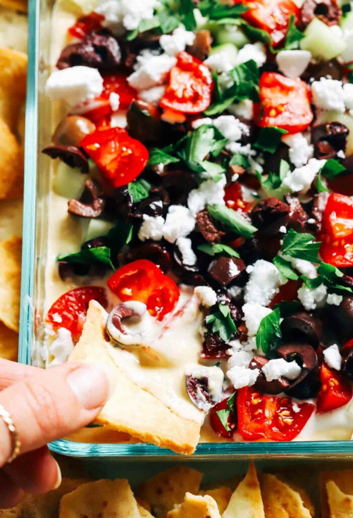 Three Layer Mediterranean Hummus Dip- Made with hummus, tzatziki, fresh herbs and vegetables, this Greek-inspired dip takes just 15-minutes to make and is perfect for a summer picnic! (dairy-free + gluten-free)