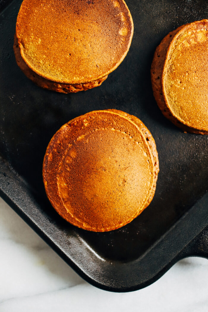 Healthy Gingerbread Pancakes- made with pumpkin puree, whole grain oats, and molasses. Each pancake packs 5 grams of protein!  Gluten-free, dairy-free and oil-free.