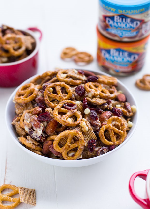 Addicting Honey Almond Holiday Snack Mix- salted almonds, pretzels, dried cranberries and chex coated with a simple honey almond butter mixture. @bluediamondalmonds #ad
