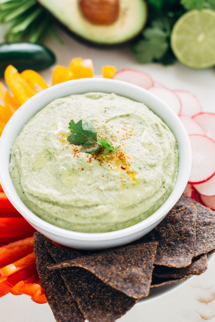 This creamy avocado hummus is packed full of flavor from fresh citrus, jalapeno, garlic and herbs. It's perfect for entertaining or for healthy snacks!