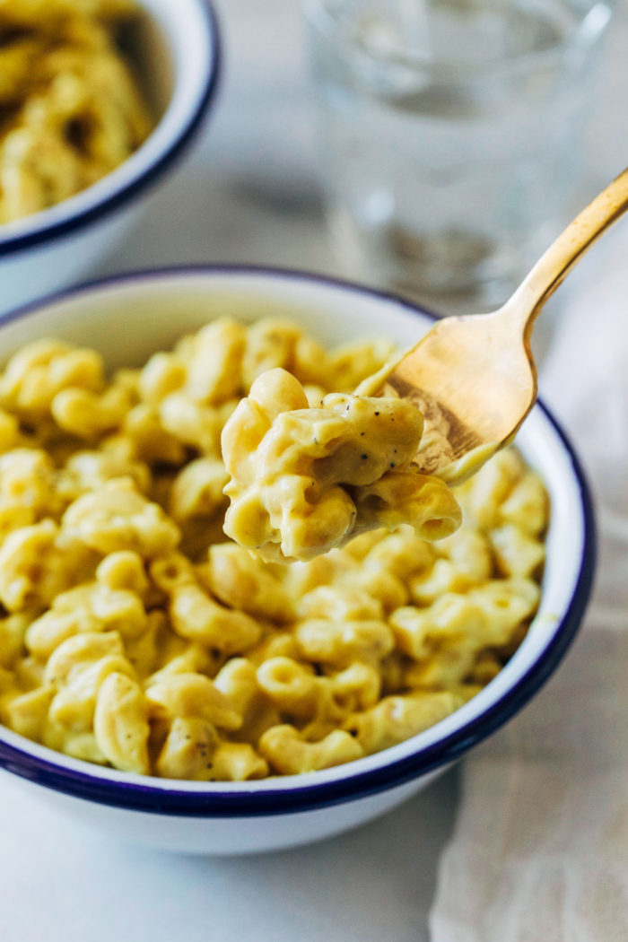 Cauliflower Macaroni and "Cheese"- a healthy vegan take on the classic comfort food made with pureed cauliflower, turmeric and nutritional yeast. It's so rich and creamy you would never guess it's dairy-free!