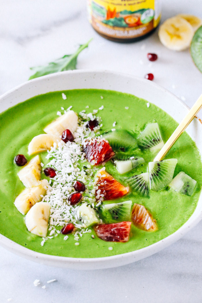 Glowing Green Smoothie Bowl- a tropical blend of mango, pineapple, banana, carrots, and kale. Packed full of vitamins and minerals to keep your skin glowing through winter! 