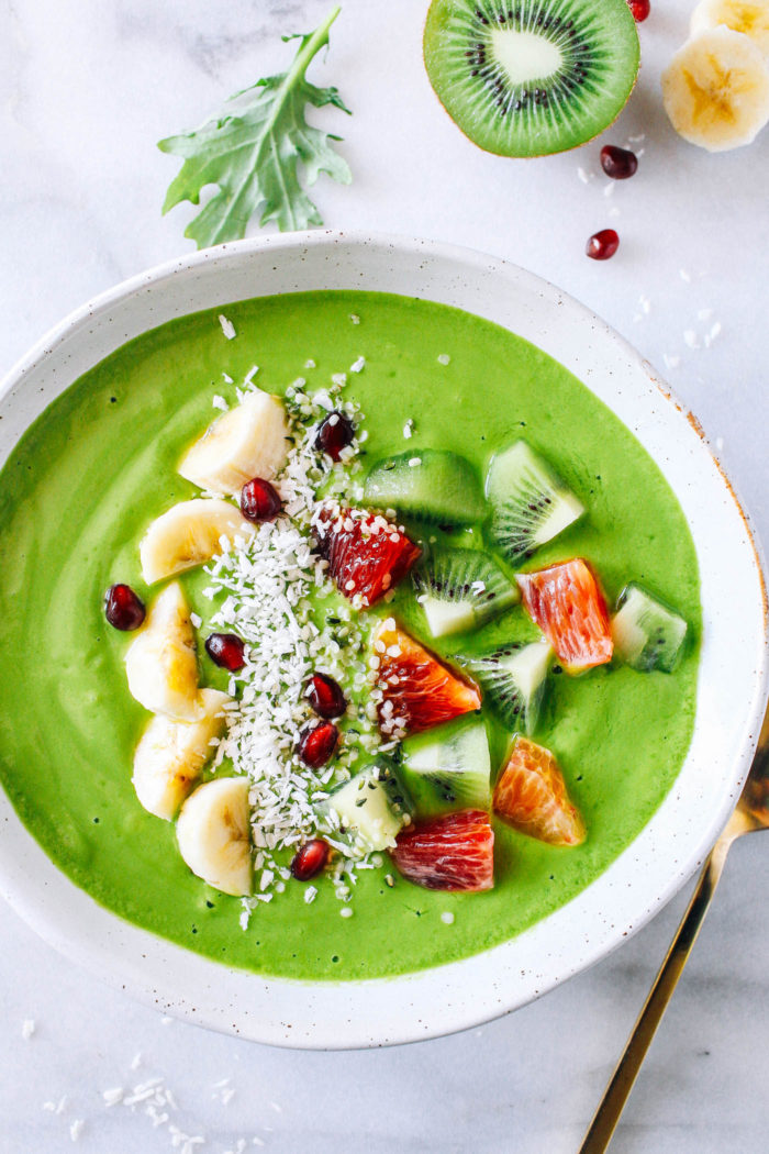 Glowing Green Smoothie Bowl- a tropical blend of mango, pineapple, banana, carrots, and kale. Packed full of vitamins and minerals to keep your skin glowing through winter! 