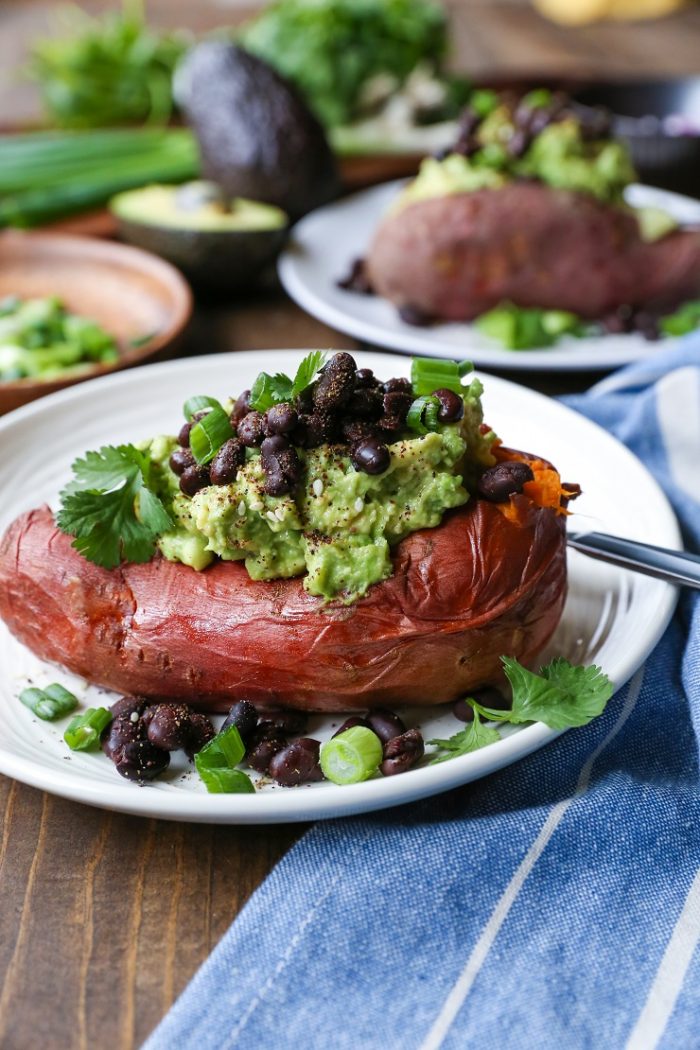 Guacamole and Black Bean Loaded Sweet Potatoes from The Roasted Root