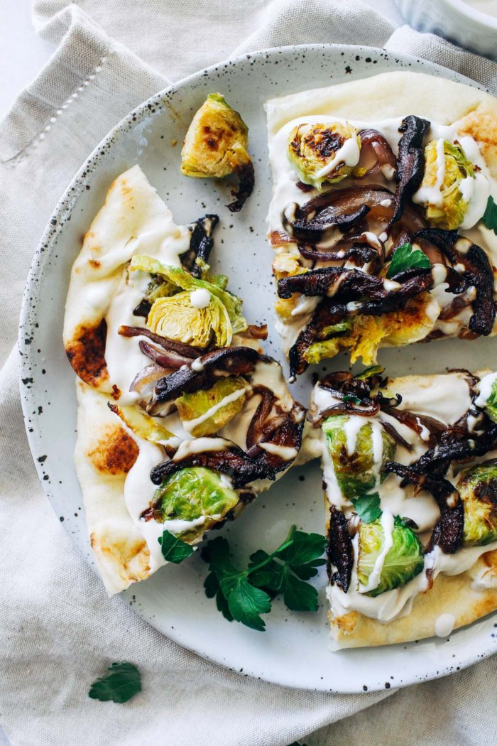 White Garlic Cashew Cream Pizza with Dijon Brussels and Shiitake Bacon- packed full of so much flavor, you won't miss the cheese in this amazing plant-based pizza! 