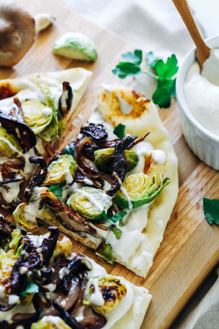 White Garlic Cashew Cream Pizza with Dijon Brussels and Shiitake Bacon- packed full of so much flavor, you won't miss the cheese in this amazing plant-based pizza! 