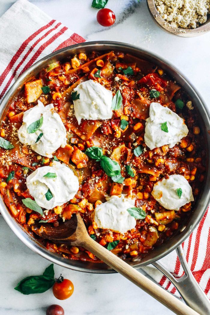 One-Pot Summer Vegetable Skillet Lasagna- juicy tomatoes, corn, zucchini, and bell peppers are cooked in one pot with pasta then topped with cashew ricotta and fresh basil for the ultimate easy-to-make summer lasagna! (vegan)