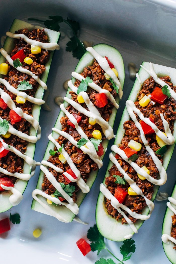 Vegan Zucchini Taco Boats- chopped walnuts and mushrooms give these plant-based taco boats a hearty texture packed full of protein and healthy fats. Drizzled with a cheesy cashew cream for ultimate bliss. (vegan, grain-free and gluten-free)
