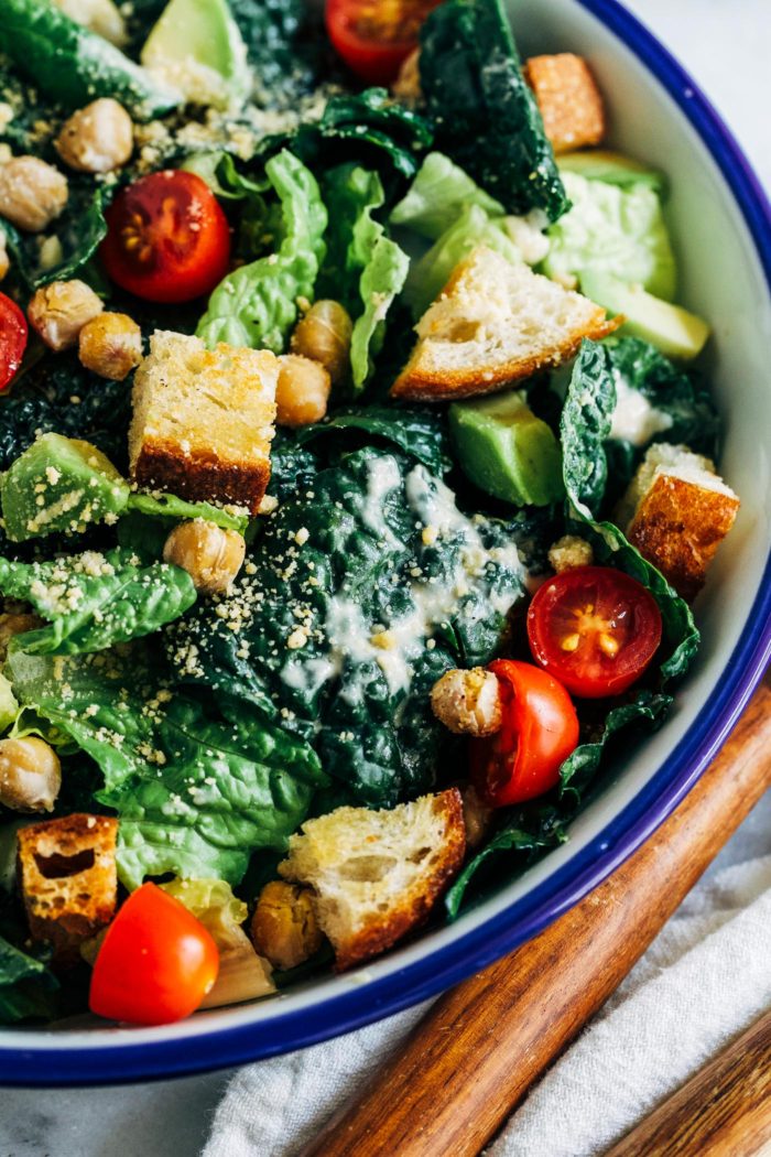 The Best Vegan Kale Caesar- a healthier caesar salad made with superfood kale and a creamy tahini-based dressing. Topped with crispy chickpeas and homemade sourdough croutons, this salad is sure to blow everyone away! 