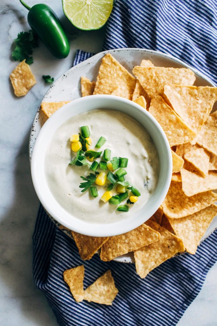 Vegan Queso Blanco- a healthier version of white queso that is just as delicious as it's cheesy counterpart. Mixed with corn and diced green chilies, it's sure to be a hit at your next get together! (vegan, gluten-free + soy-free)