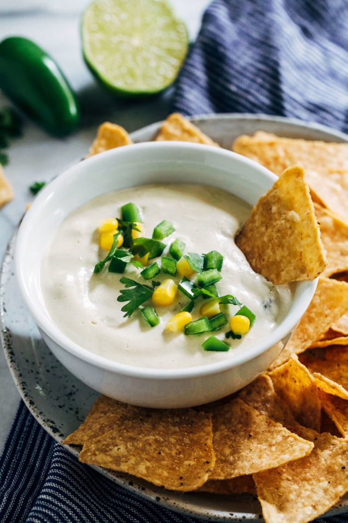 Vegan Queso Blanco- a healthier version of white queso that is just as delicious as it's cheesy counterpart. Mixed with corn and diced green chilies, it's sure to be a hit at your next get together! (vegan, gluten-free + soy-free)
