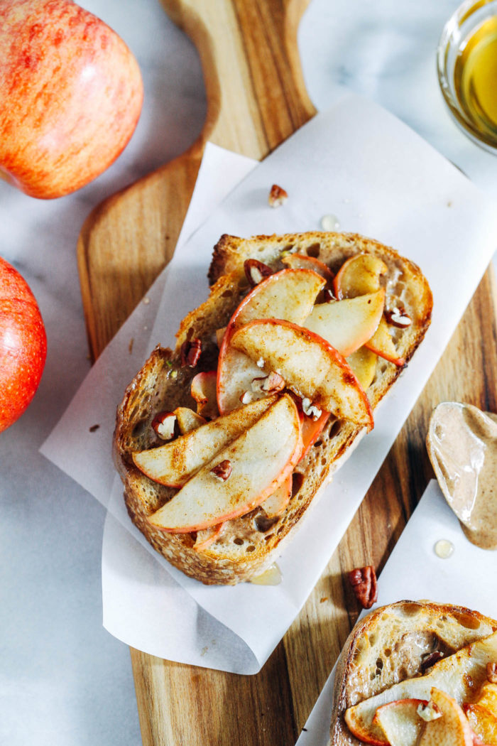 Gingered Apple and Almond Butter Toast- roasted apple slices tossed with honey and spices make for a sinfully delicious almond butter toast topping. Perfect for a healthy snack or dessert! 