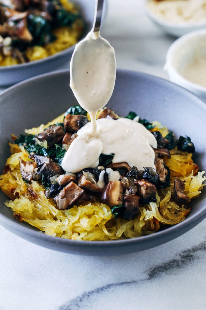 Spaghetti Squash with Mushrooms, Kale and Cashew Alfredo- roasted spaghetti squash is topped with balsamic mushrooms, garlicky kale, and creamy cashew alfredo. The perfect healthy comfort food!