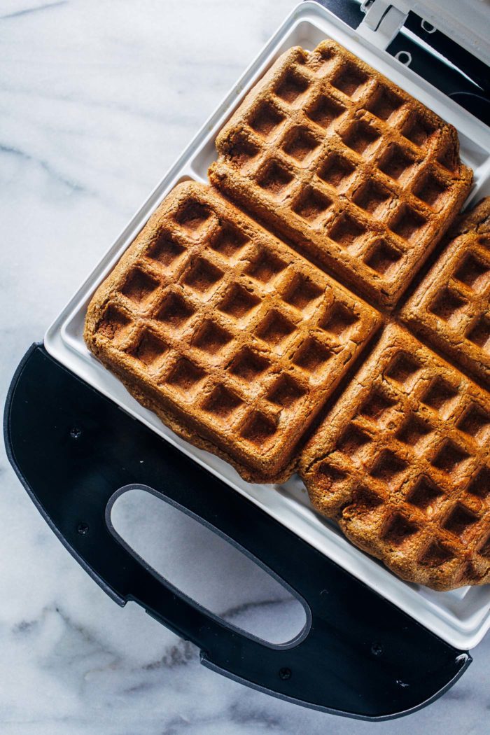 Flourless Vegan Banana Bread Waffles- made easy in a blender, these gluten-free waffles are naturally sweetened and full of flavor. They freeze well too, making them perfect to prep for weekday mornings!