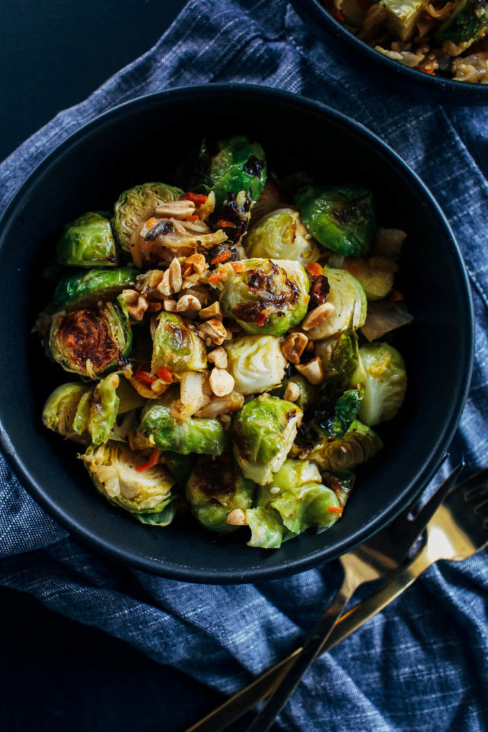 Kimchi Brussels Sprouts- brussels sprouts roasted in a 'cheesy' sauce and served with kimchi and crushed peanuts. Addictingly delicious and packed full of gut friendly probiotics.
