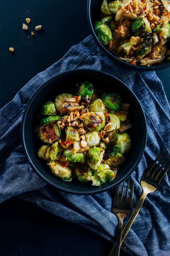 Kimchi Brussels Sprouts- brussels sprouts roasted in a 'cheesy' sauce and served with kimchi and crushed peanuts. Addictingly delicious and packed full of gut friendly probiotics.