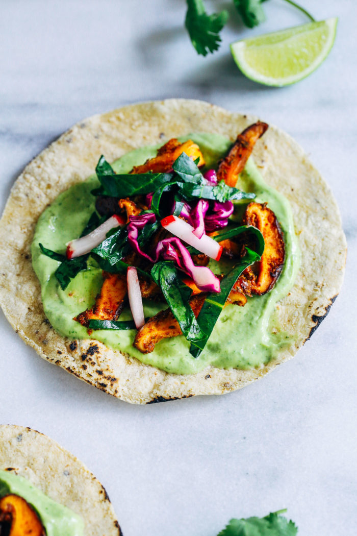 Blackened Mushroom Tacos with Collard Green Slaw- packed full of superfood antioxidant power, these tacos are made with sautéed mushrooms, avocado cream and a tangy collard green slaw. Eating your greens has never tasted better! (vegan, gluten-free, soy-free)