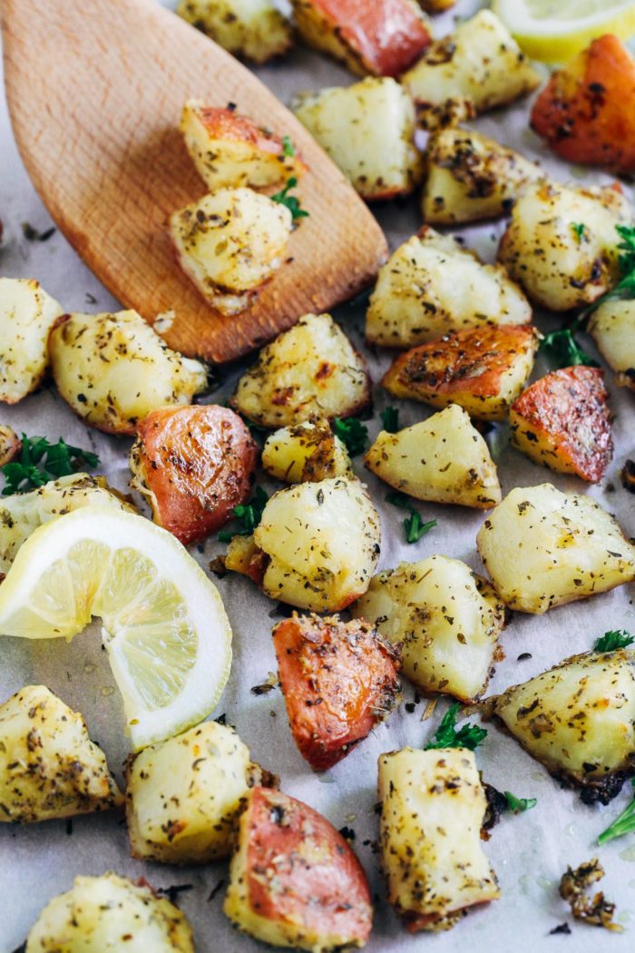 Greek Lemon Roasted Potatoes- tossed in a mixture of olive oil, lemon, mustard, and herbs, these crispy gems are sure to become your new favorite way to eat potatoes! 