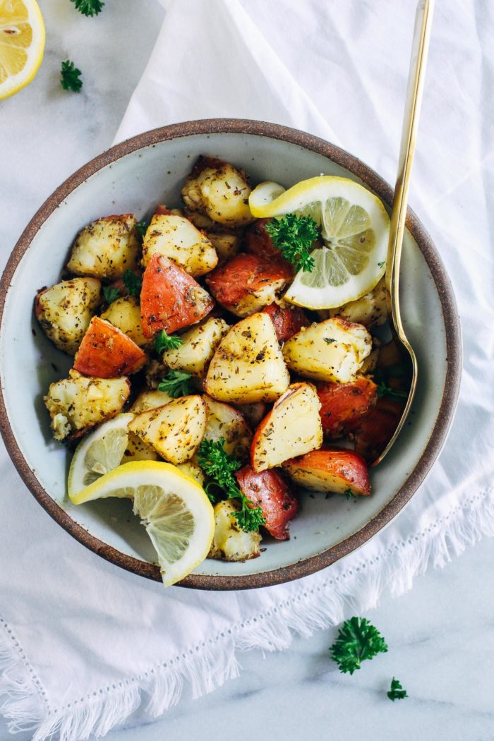 Greek Lemon Roasted Potatoes- tossed in a mixture of olive oil, lemon, mustard, and herbs, these crispy gems are sure to become your new favorite way to eat potatoes! 