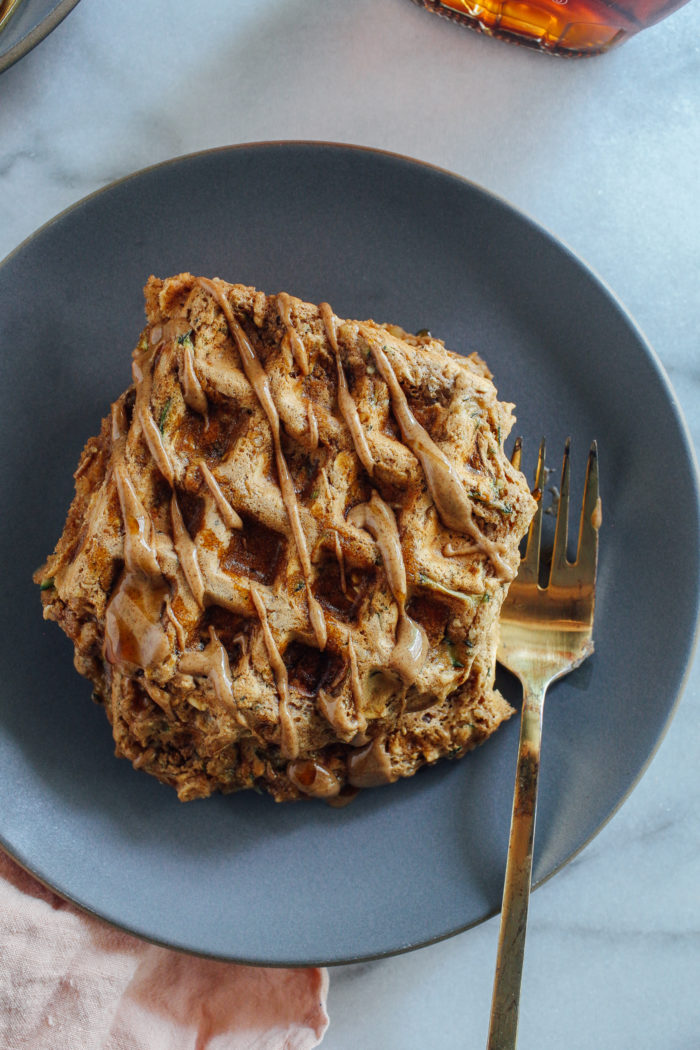Zucchini Oat Protein Waffles- made with whole grain rolled oats, hemp seeds, almond butter and yogurt, these waffles are packed full of plant-based protein and fiber. They freeze well and are perfect to prep for busy weekday mornings! #vegan #glutenfree #healthybreakfast #waffles #plantbased #protein