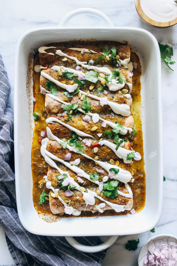 Vegan Butternut Squash Enchiladas- stuffed with roasted butternut squash, brussels sprouts, and black beans, these enchiladas are warming and packed full of nutrition!  #plantbased #veganglutenfree #healthymeals