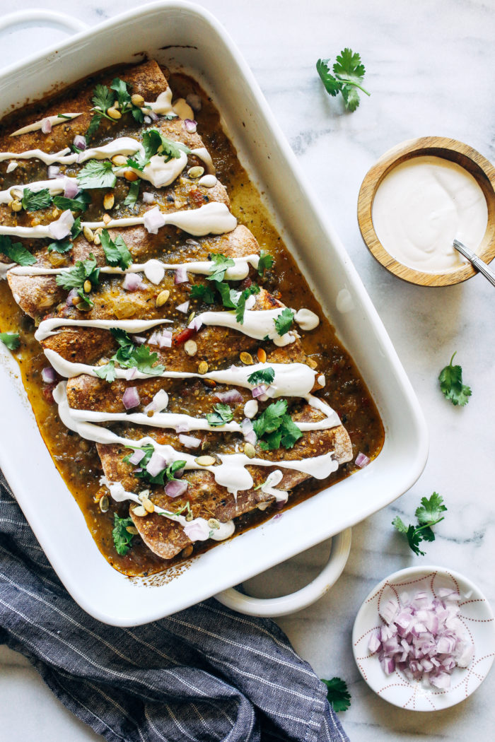 Vegan Butternut Squash Enchiladas- stuffed with roasted butternut squash, brussels sprouts, and black beans, these enchiladas are warming and packed full of nutrition!  #plantbased #veganglutenfree #healthymeals