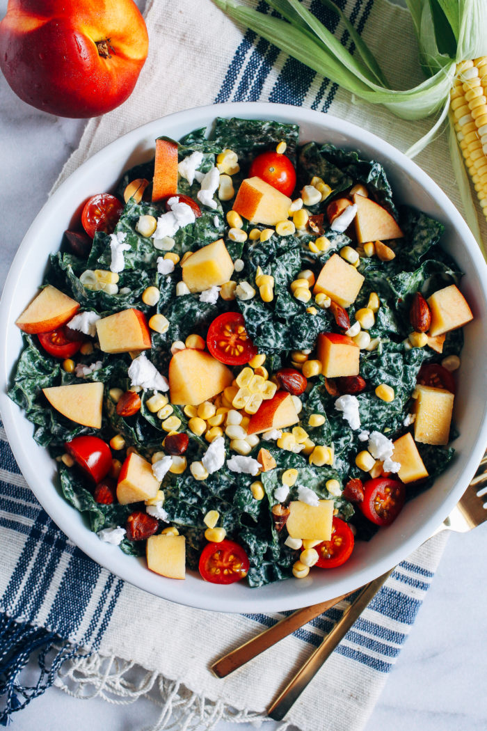 Summer Kale Salad- massaged kale gets topped with fresh nectarines, tomatoes and corn for a light and refreshing salad that's perfect for entertaining or prepping for lunches!