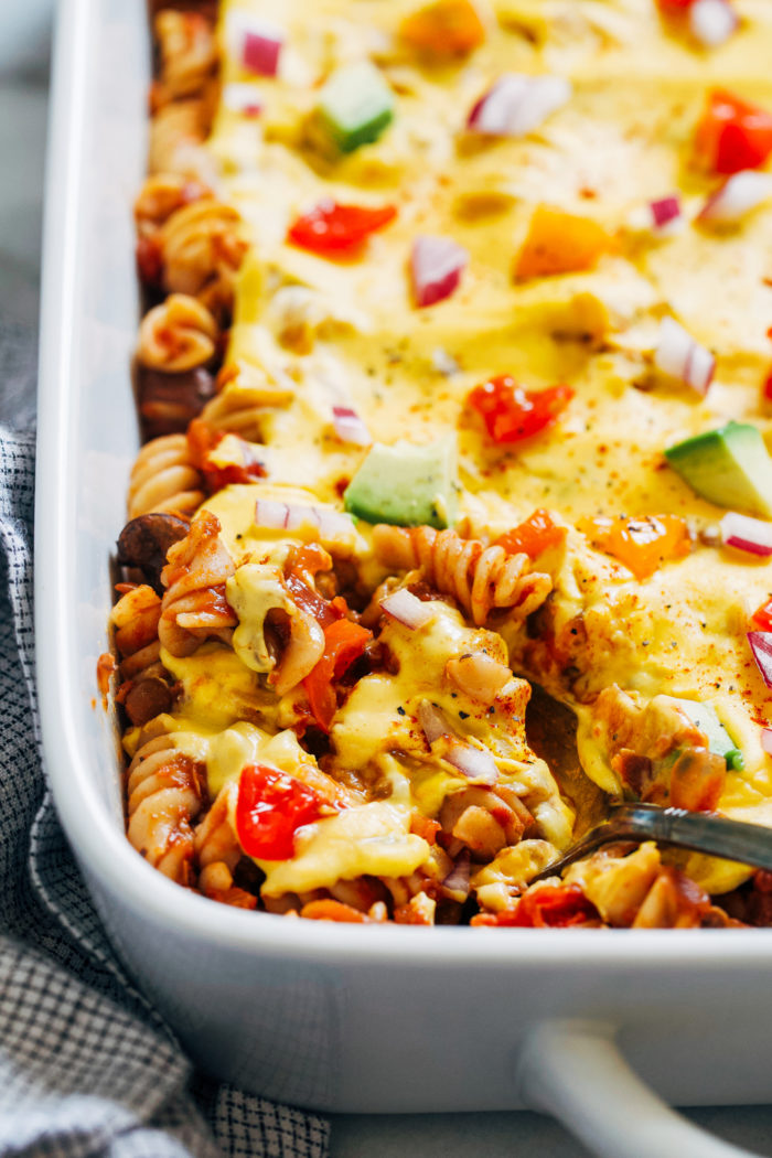 'Cheesy' Lentil Chili Casserole- spiral pasta layered with savory lentil chili and a creamy cheese sauce. Hearty and satisfying, it's the perfect healthy comfort food! #vegan #plantbased #glutenfree