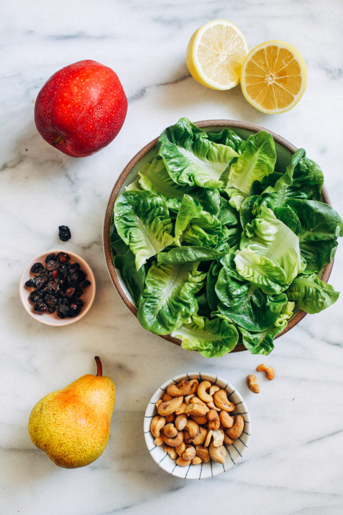 Winter Fruit Salad with Lemon Dijon Dressing- fresh apples and pears served on a bed of crisp lettuce with salted cashews, tart cranberries and a lemon dijon dressing that will keep everyone coming back for more!