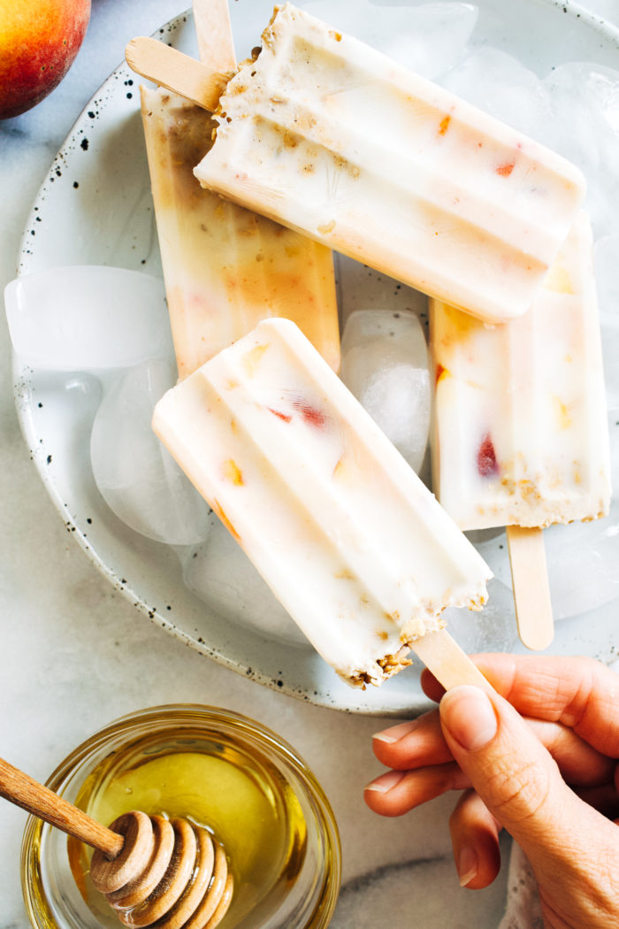 Peaches and Cream Yogurt Popsicles- All you need is 4 simple ingredients and 20 minutes to prep these healthy and delicious popsicles. Dairy-free and toddler approved!