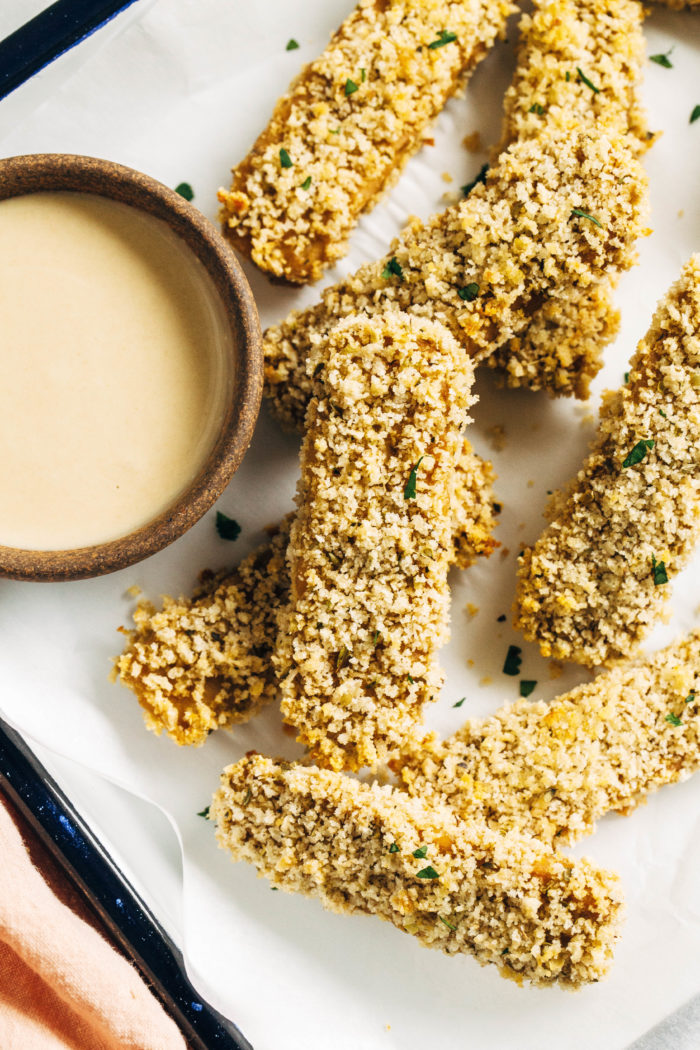 Crispy Baked Tempeh Fingers- Made with whole food ingredients these crispy tempeh strips are packed with protein and iron, making them a great alternative to processed faux meat.