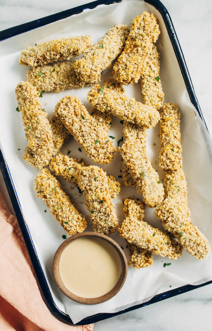 Crispy Baked Tempeh Fingers- Made with whole food ingredients these crispy tempeh strips are packed with protein and iron, making them a great alternative to processed faux meat.