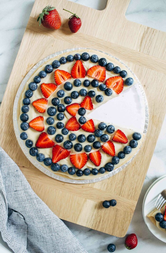 Vegan Dessert Pizza- made with a crisp gluten-free crust and a lightly sweetened cream cheese frosting, this dessert pizza is the perfect way to showcase summertime fruit!