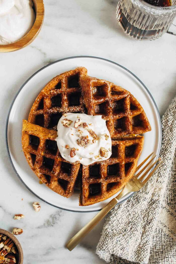 Pumpkin Protein Waffles- made with pumpkin puree and fall spices, each waffle packs 16 grams of protein and 3 milligrams of iron. Perfect to prep ahead for busy mornings! (dairy-free with GF option)