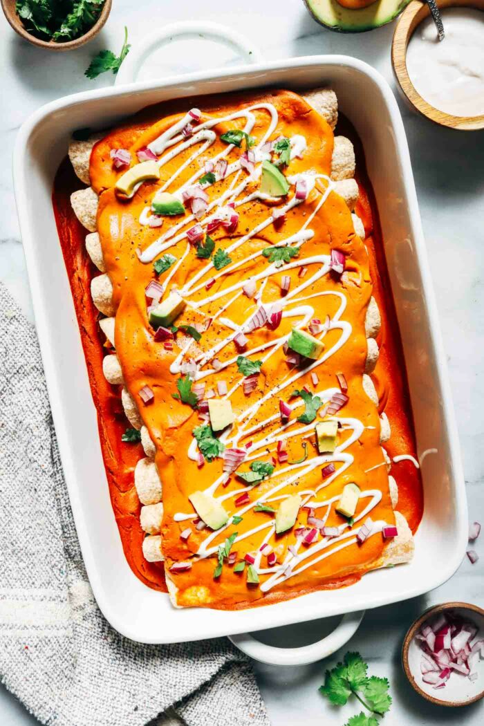 Vegan Pumpkin Black Bean Enchiladas- topped with a cheesy pumpkin sauce, these enchiladas are loaded with flavor and packed with protein! (gluten-free option)
