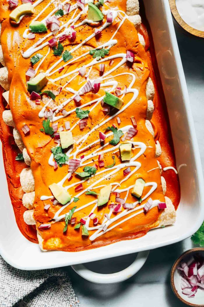 Vegan Pumpkin Black Bean Enchiladas- topped with a cheesy pumpkin sauce, these enchiladas are loaded with flavor and packed with protein! (gluten-free option)