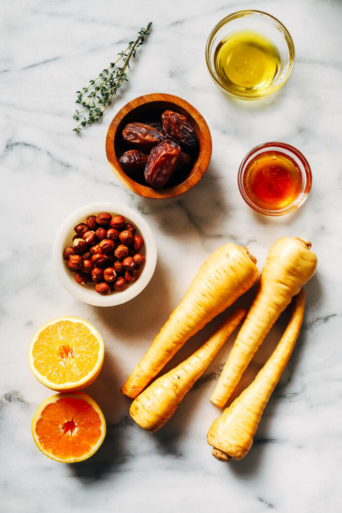 Honey Roasted Parsnips with Dates and Hazelnuts- Crisp parsnips baked in a simple glaze of olive oil, honey and orange zest. The addition of warm dates and buttery roasted hazelnuts makes for combination that will make this side dish the star of the show. (gluten-free)