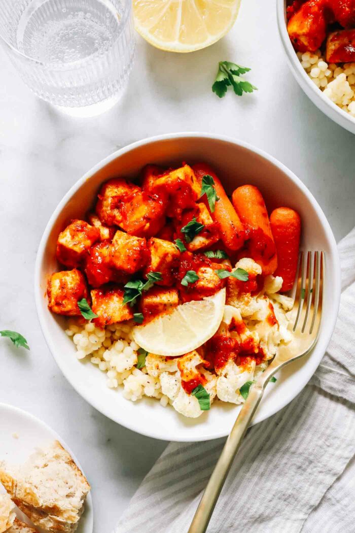 Honey Harissa Tofu Bowls- Crispy baked tofu coated in a flavorful honey harissa sauce and served with roasted vegetables and couscous for a protein-packed nourishing meal!  (vegan + gluten-free option)
