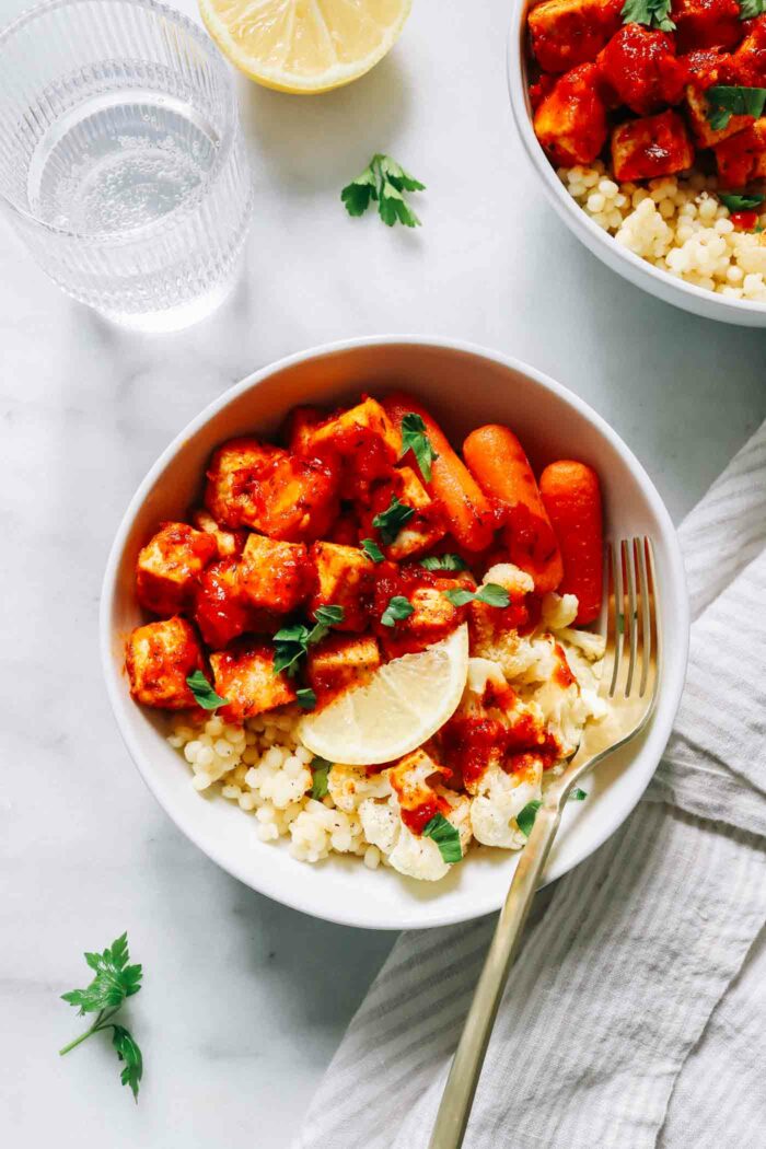 Honey Harissa Tofu Bowls- Crispy baked tofu gets coated in a flavorful honey harissa sauce and served with roasted vegetables and couscous for a protein-packed nourishing meal!  (vegan + gluten-free option)