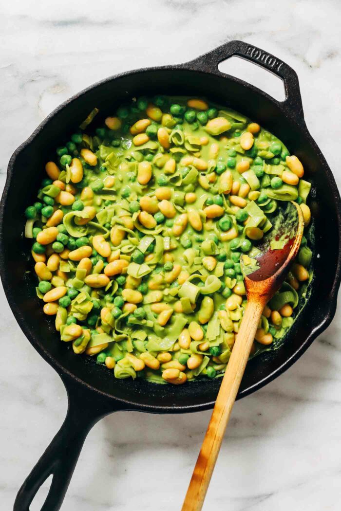 Green Saucy Beans- made with leeks and fresh basil, these green saucy beans are perfect to serve alongside your favorite protein or on top of crispy toast! 