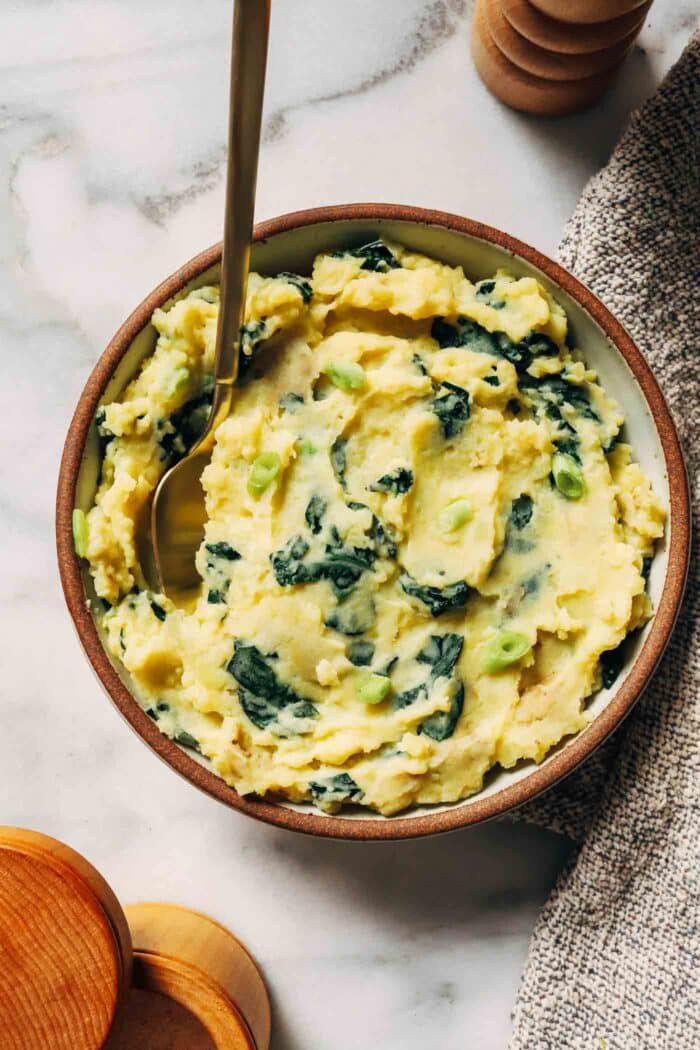 Vegan Colcannon- a plant-based take on an Irish classic featuring creamy mashed potatoes paired with sautéed kale and green onions. 