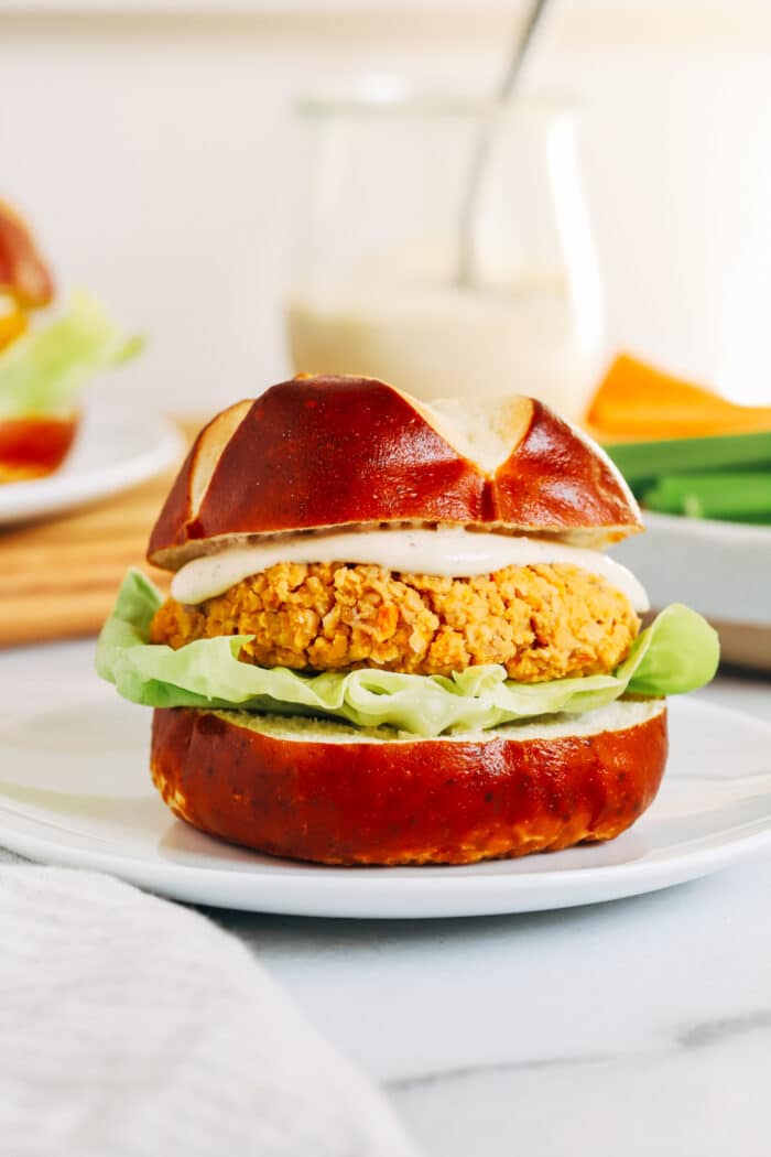 Buffalo Chickpea Burgers- Made with just 7-ingredients, these vegan and gluten-free chickpea burgers are packed with flavor. Perfect to prep for fiber-packed lunches or dinner! 