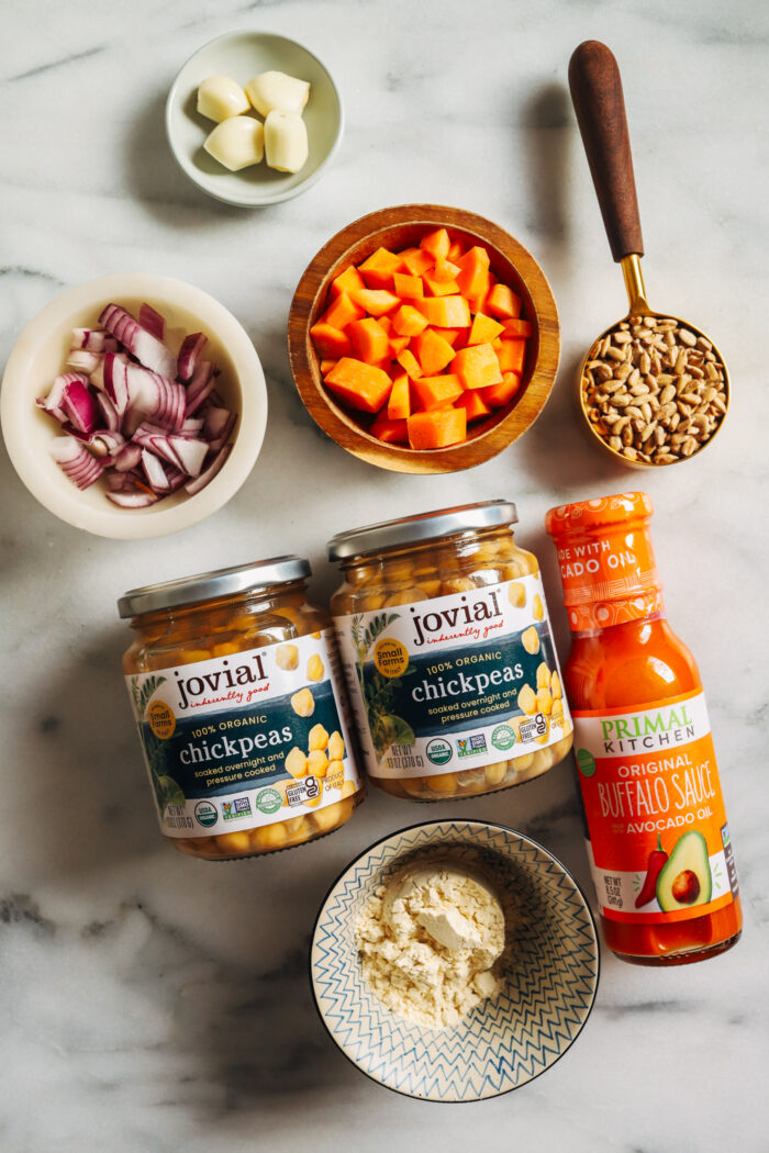 Buffalo Chickpea Burgers- Made with just 7-ingredients, these vegan and gluten-free chickpea burgers are packed with flavor. Perfect to prep for fiber-packed lunches or dinner! 
