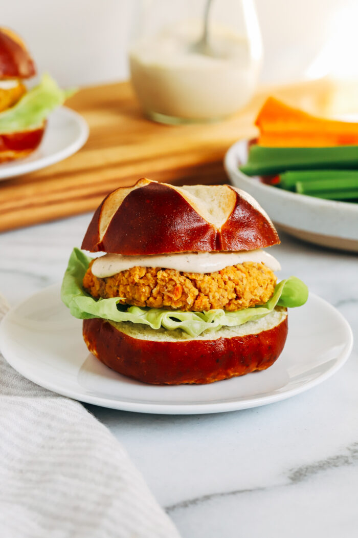 Buffalo Chickpea Burgers- Made with just 7-ingredients, these vegan and gluten-free chickpea burgers are packed with flavor. Perfect to prep for fiber-packed lunches or dinner! 